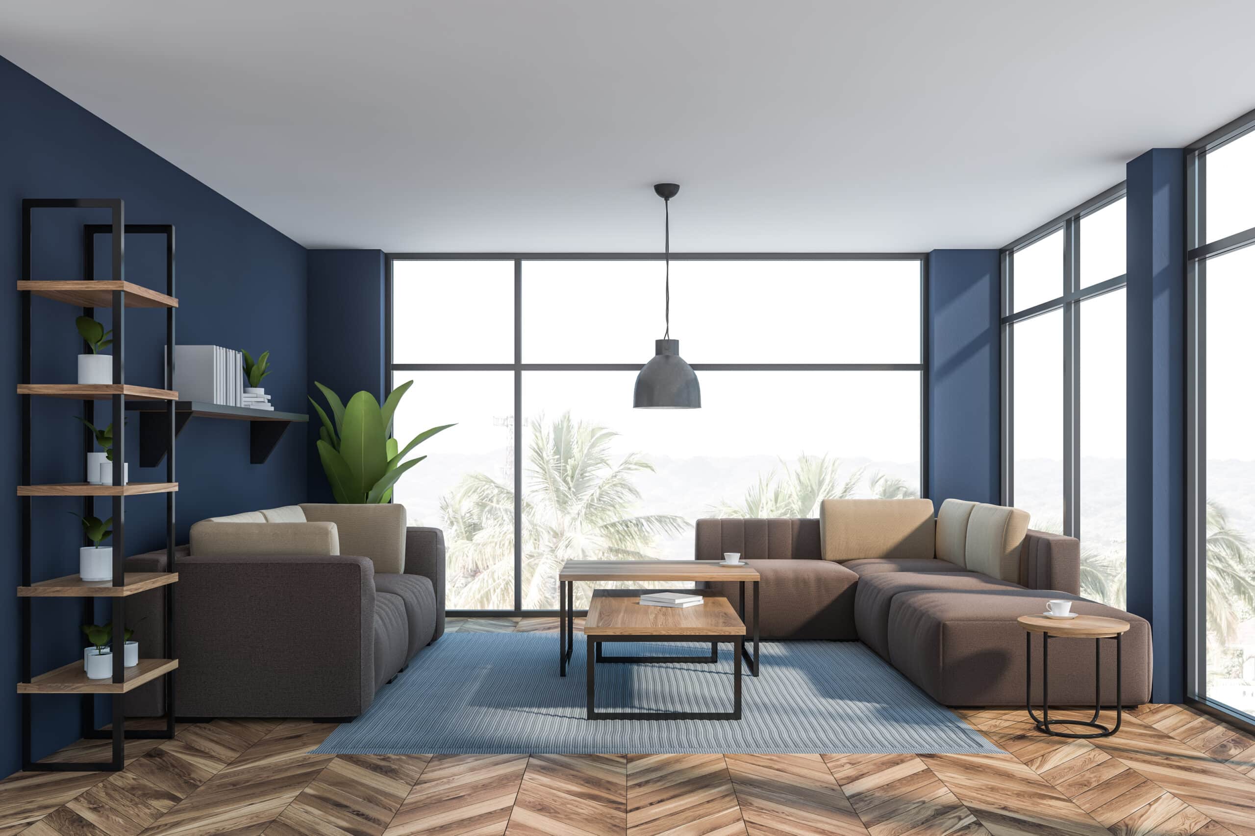 Home remodeling: Interior of a luxury living room or office lounge area with dark blue walls, wooden floors, beige sofas standing near wooden coffee tables, and shelves with plants and books, by Mana Home Services.