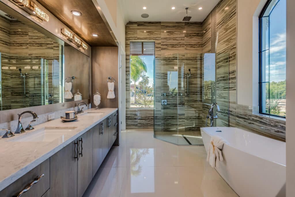 Home remodeling featuring a free-standing tub and a big glass shower in the master bathroom with amazing views, by Mana Home Services.
