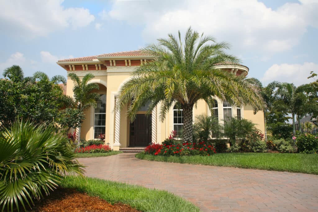 Upscale Home, Enhancing its appeal with tropical landscaping, including palm tree trimming.